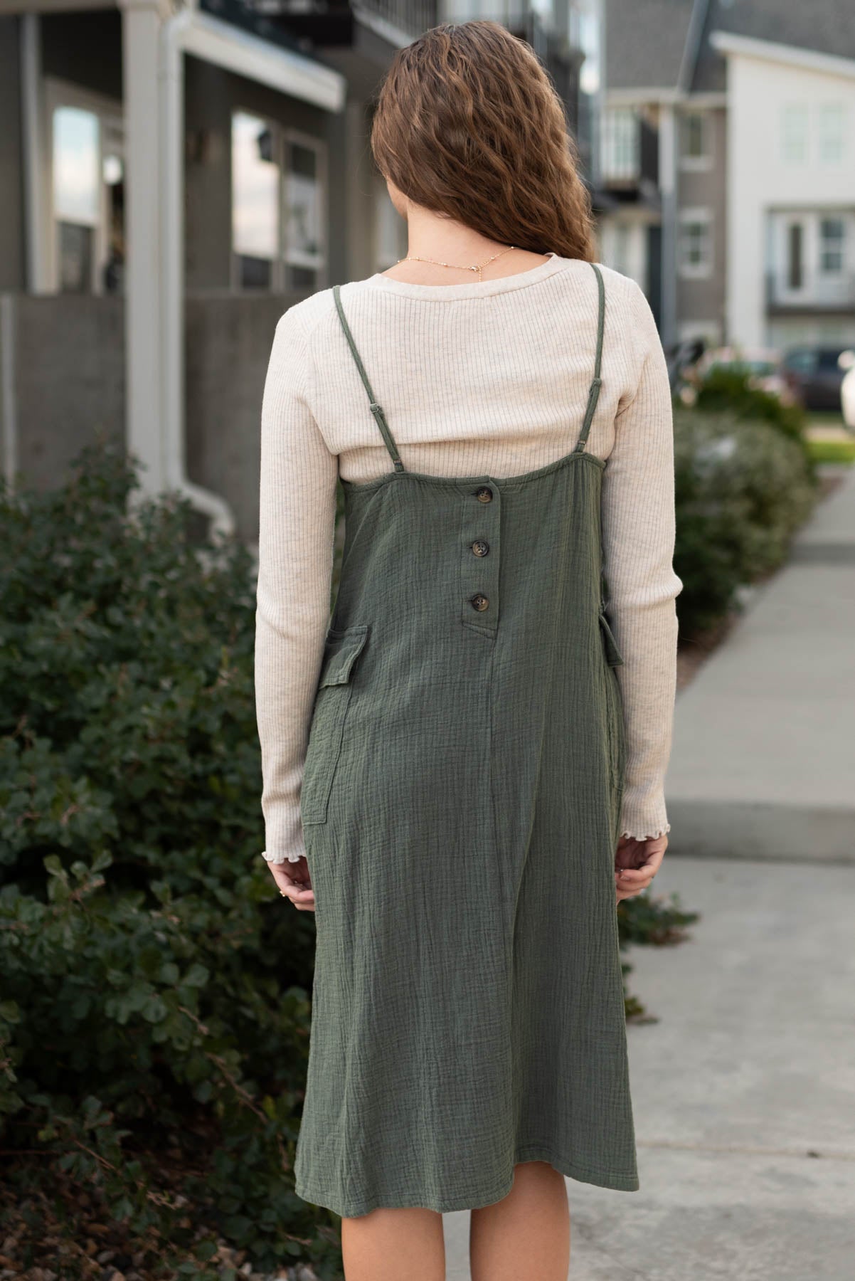 Back view of the dark olive dress with button closer