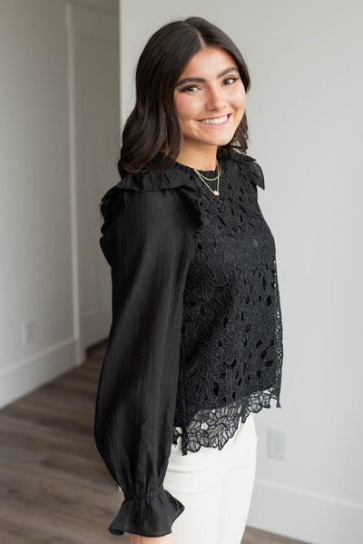 Side view of the black lace top with the ruffle on the shoulder