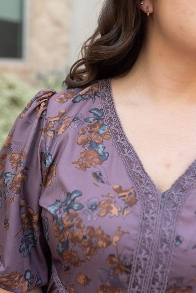 Close up of the lace on the plum floral tiered  dress in plus size