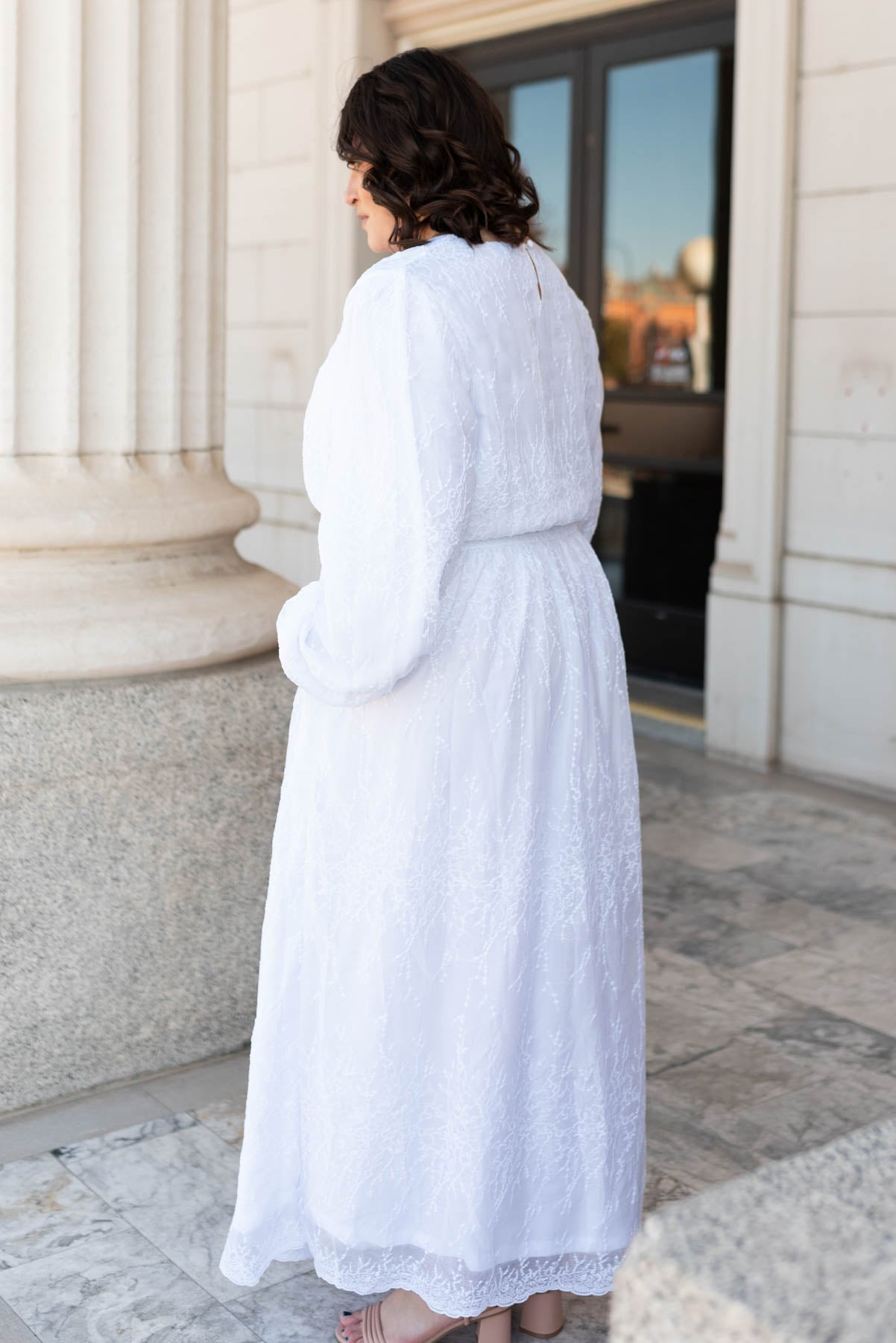 Side view of the white embroidered maxi dress