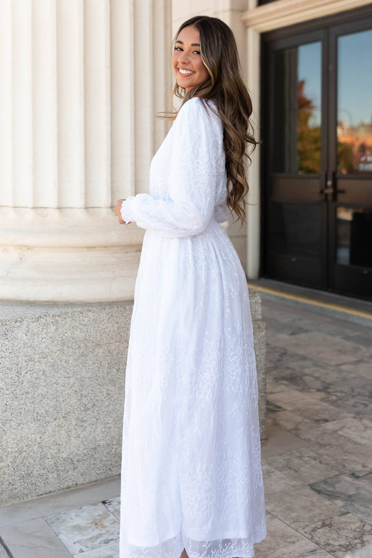 Side view of teh white embroidered maxi dress