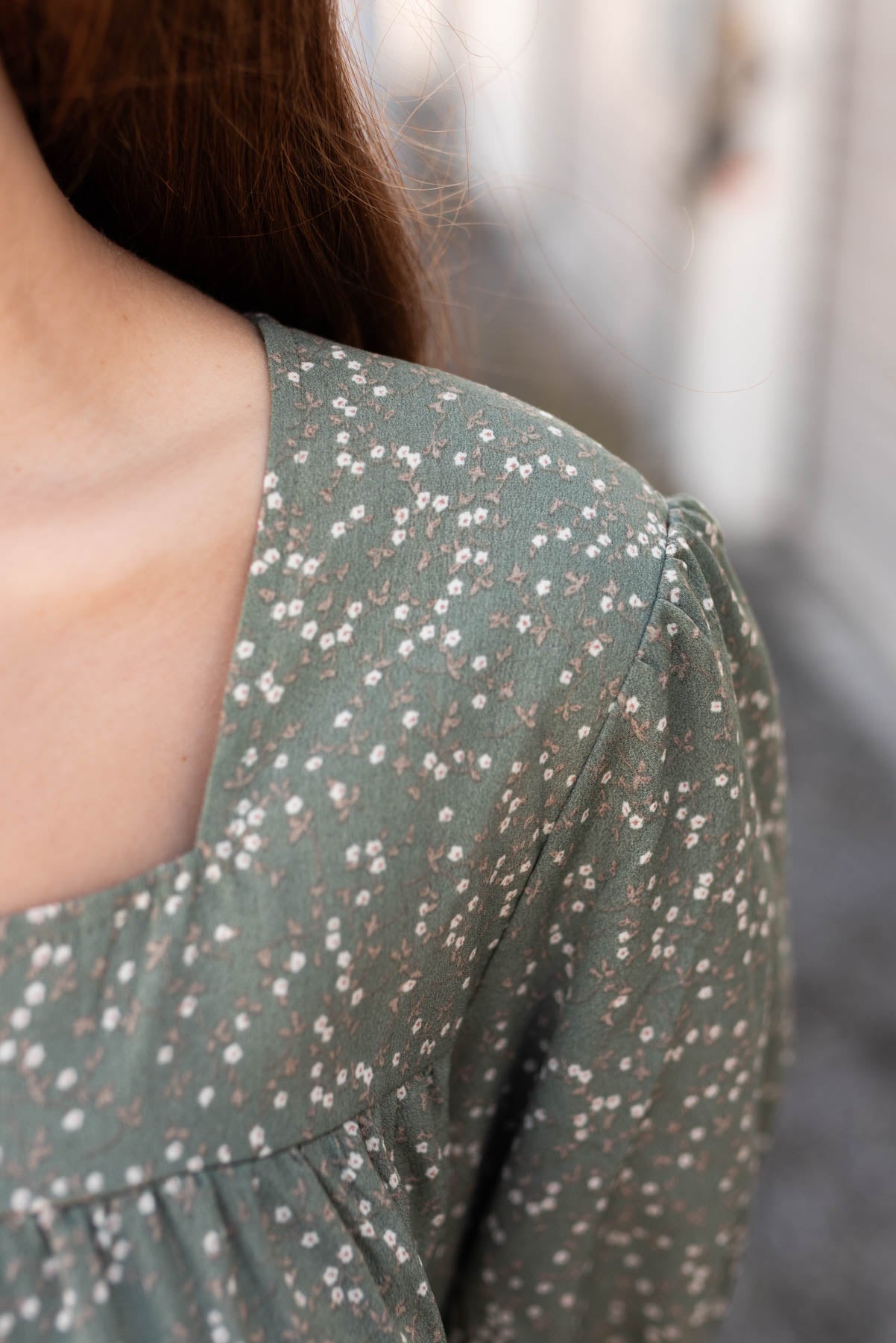 Close up of the fabric and neckline of the sage floral tiered dress