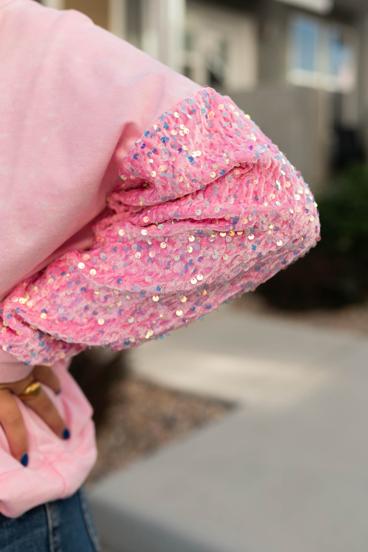 Close up sleeve of a pink pullover