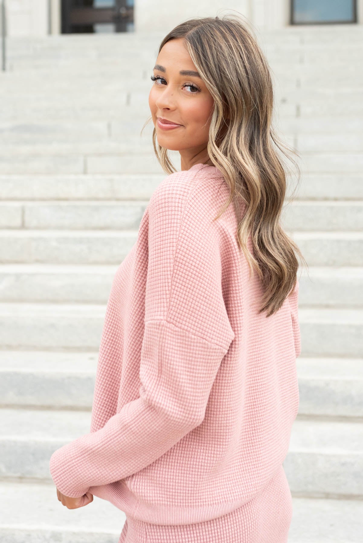 Side view of the blush pink sweater