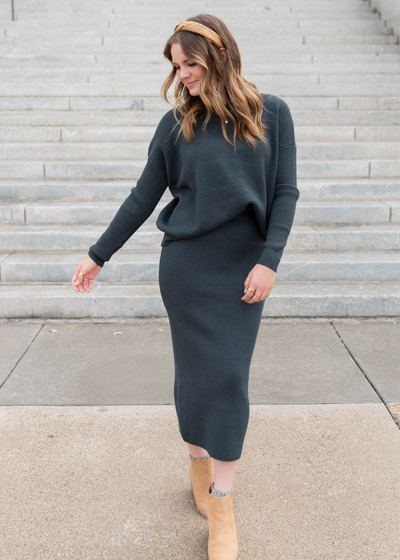 Minnight navy sweater tucked into the midnight navy skirt that is sold separately