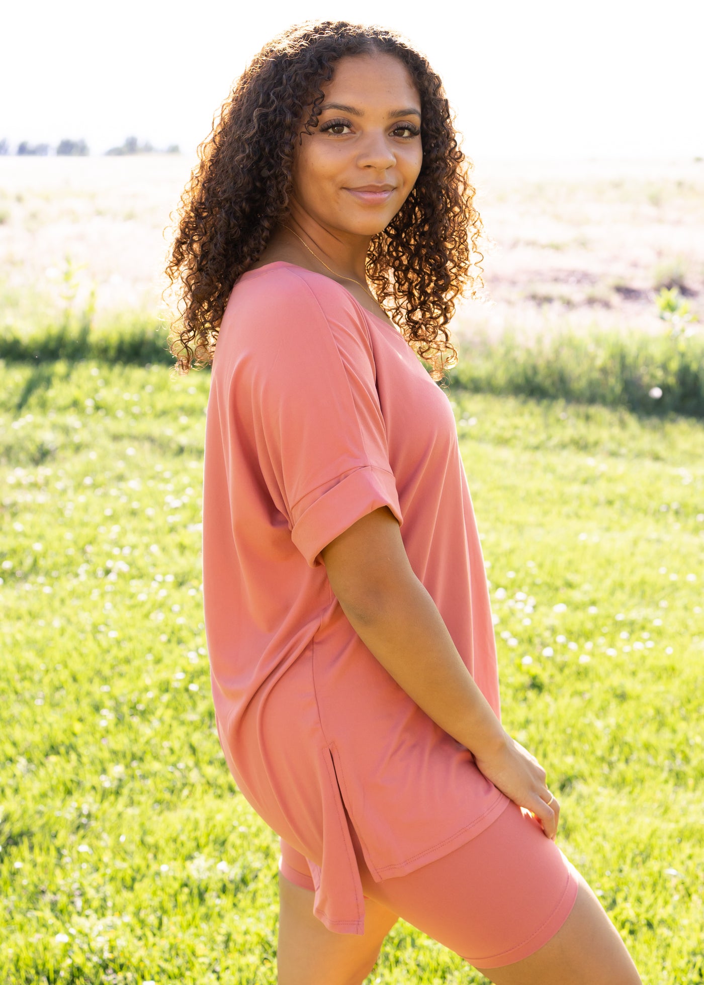 Side view of a ash rose set with a short sleeve tee and biker shorts