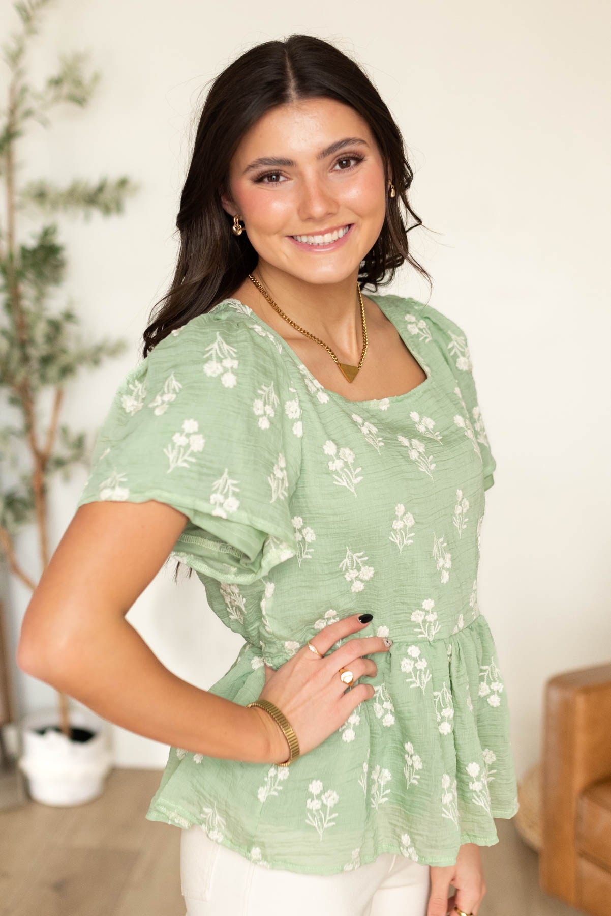 Side view of the lined sage floral blouse