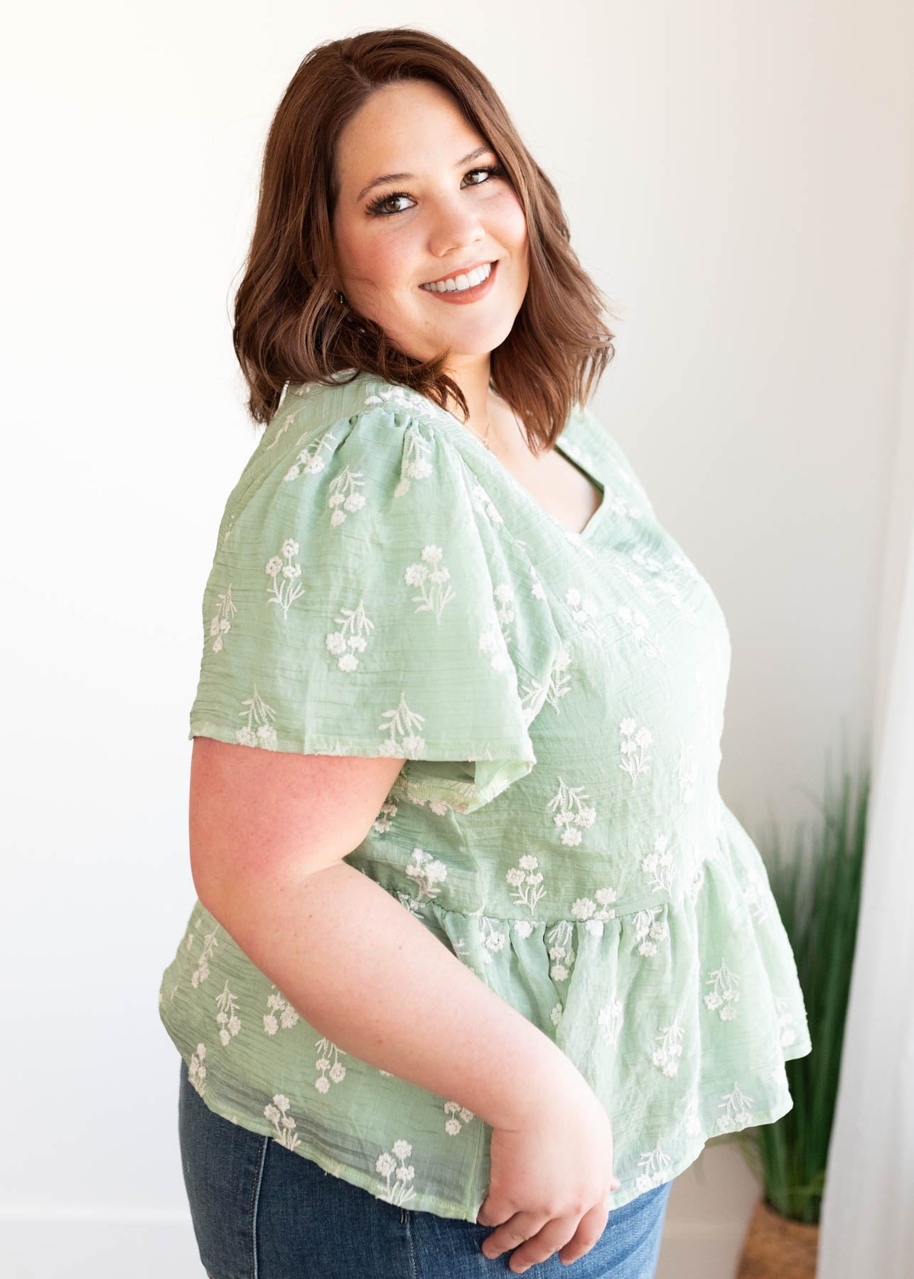 Side view of the plus size sage floral blouse