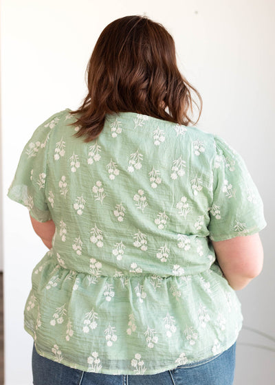 Back view of the plus size sage floral blouse