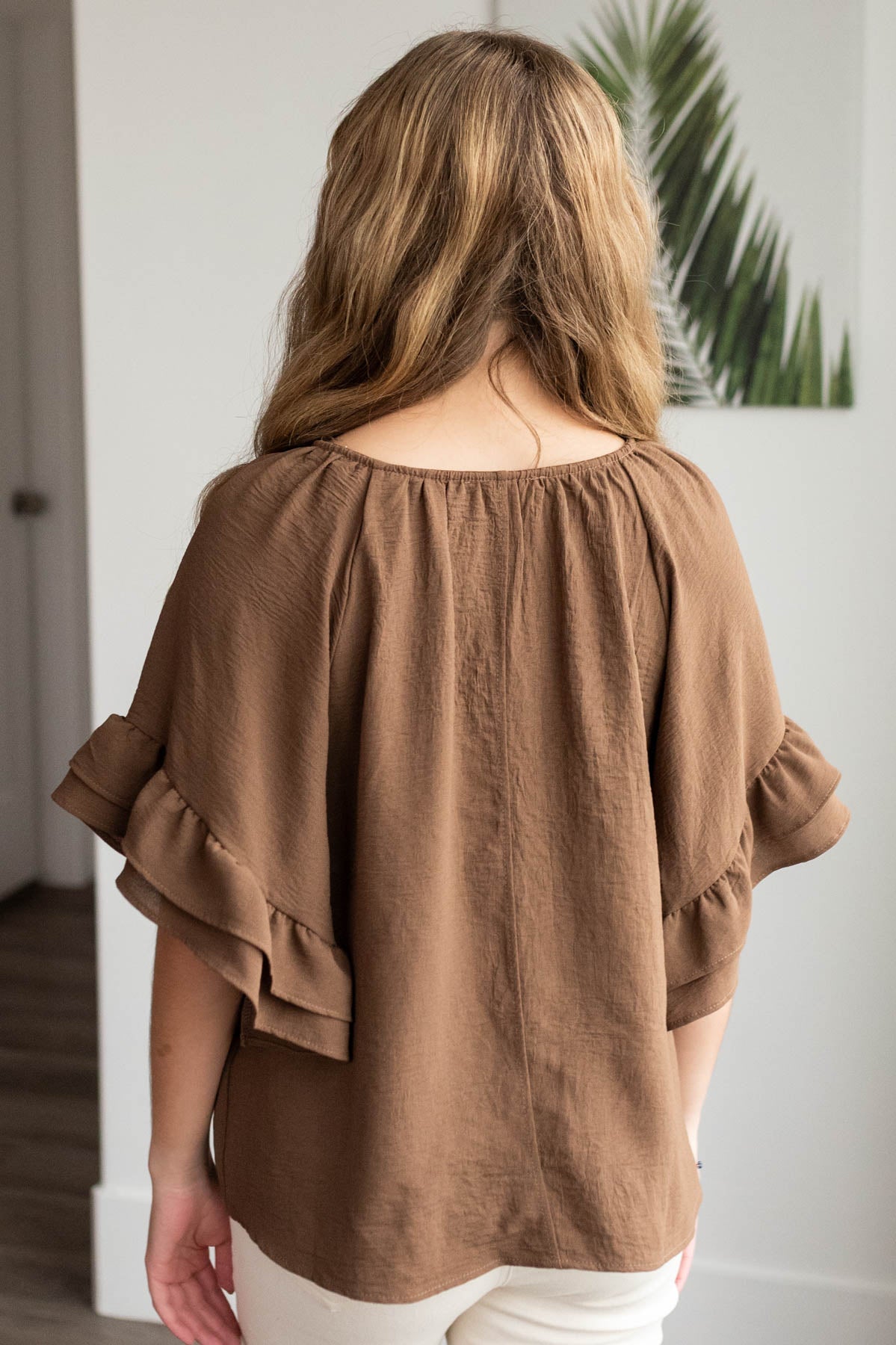 Back view of the cocoa ruffle sleeve blouse