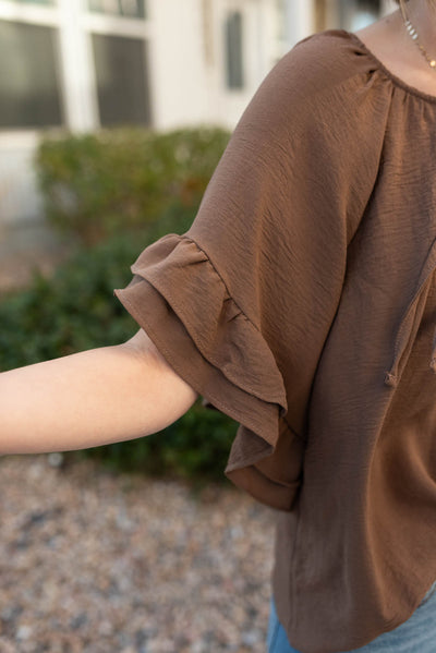 Close up of the ruffle on the sleeve of the cocoa ruffle sleeve blouse