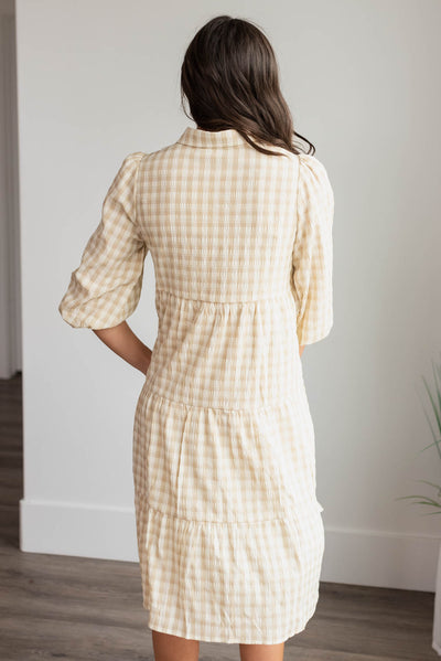 Back view of the beige gingham button down dress