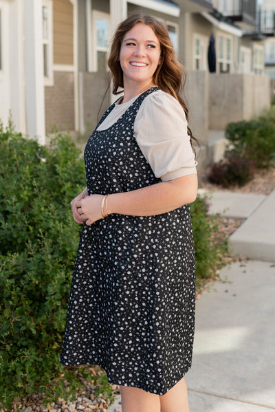 Side view of the plus size black floral jumper dress