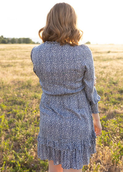 Back view of a long sleeve blue leopard dress