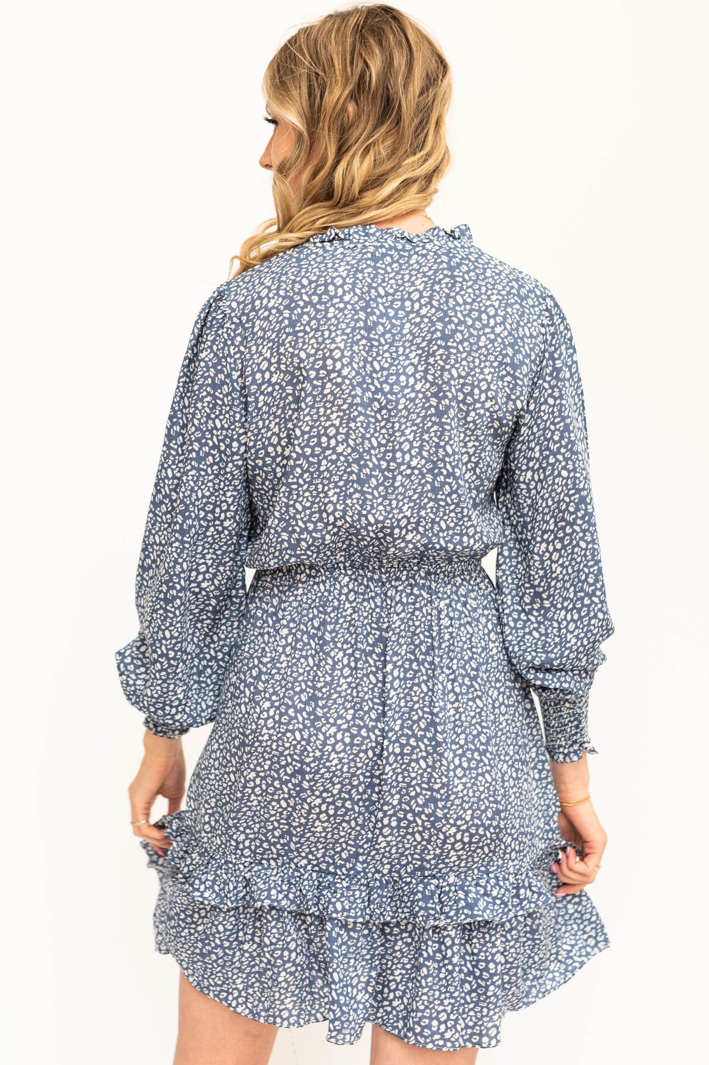 Back view of a long sleeve blue leopard dress.