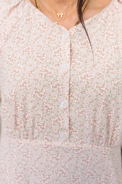 Close up of the buttons and fabric on the blush floral dress