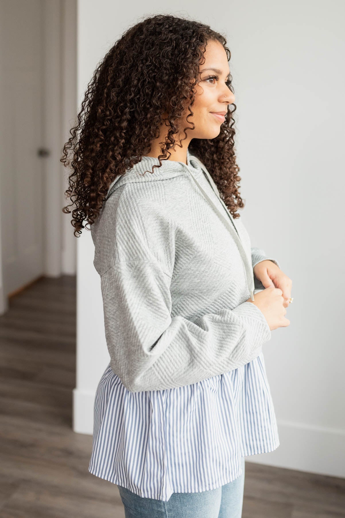 Side view of the heather grey textured hoodie