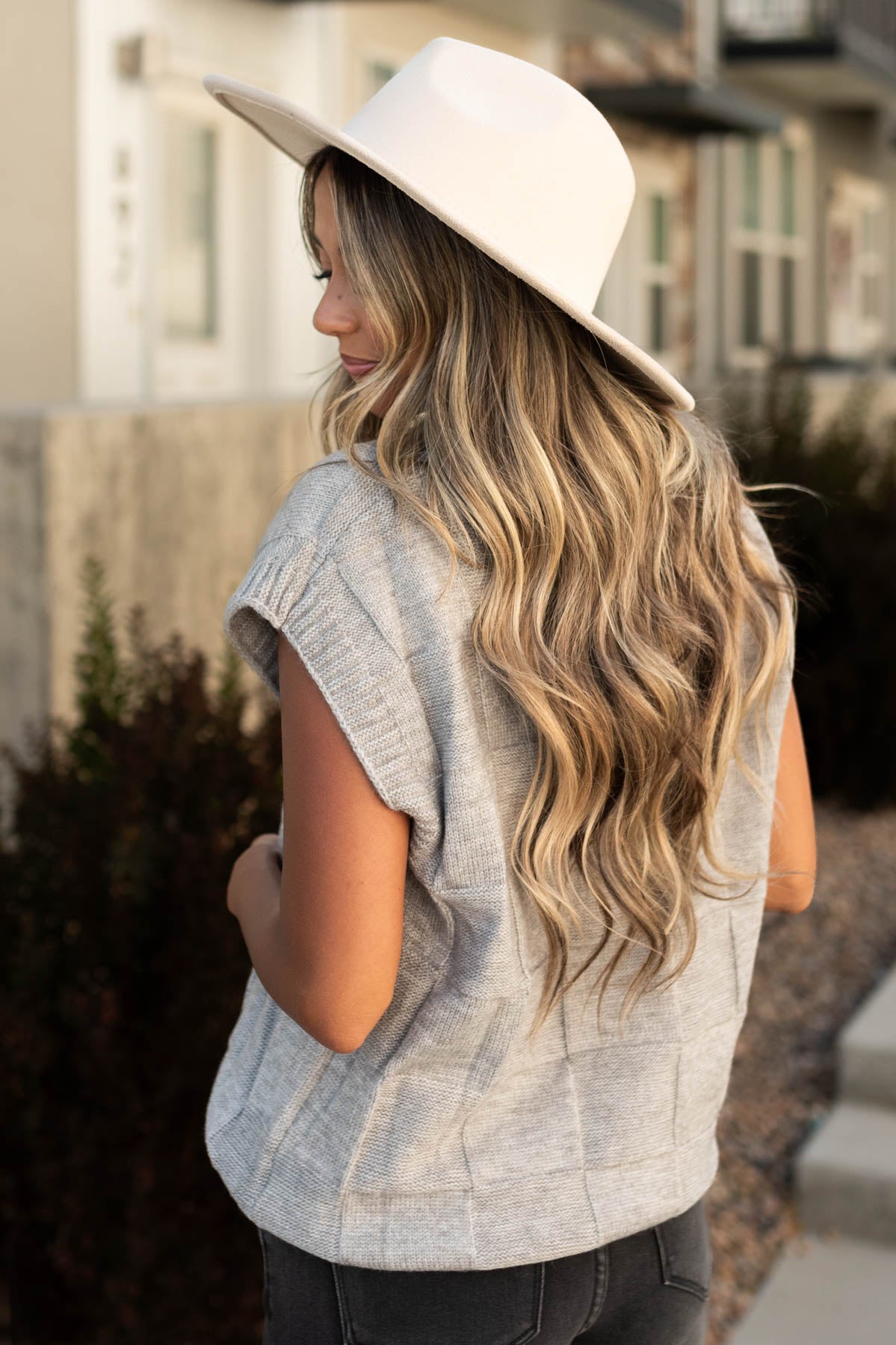 Side view of a grey sweater vest