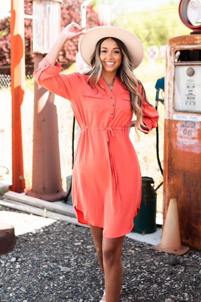 Terracotta dress with collar, front pockets and buttons that ties at the waist 