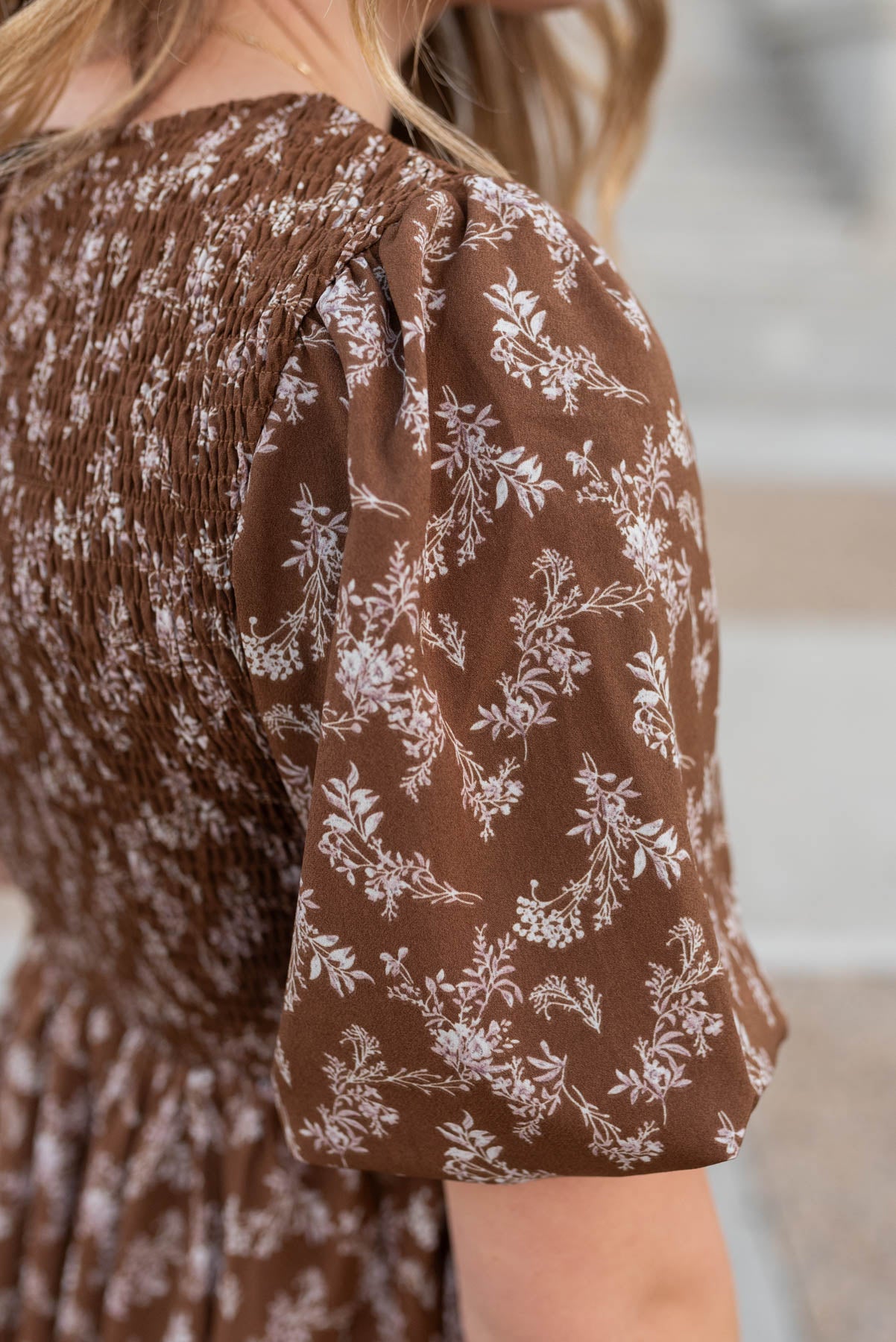 Close up of the fabric on the brown floral smocked dress