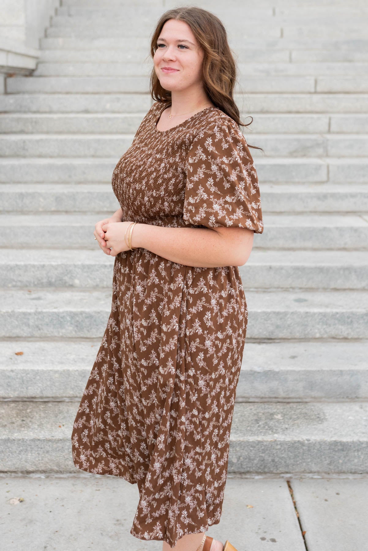 Side view of the brown floral smocked dress in plus size