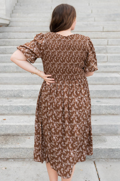 Back view of the plus size brown floral smocked dress 