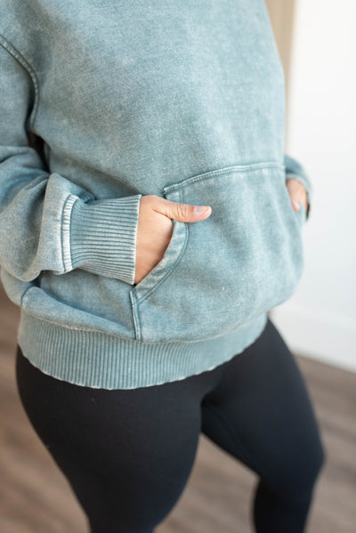 Close up of the pocket and cuffs on ash jade fleece hoodie