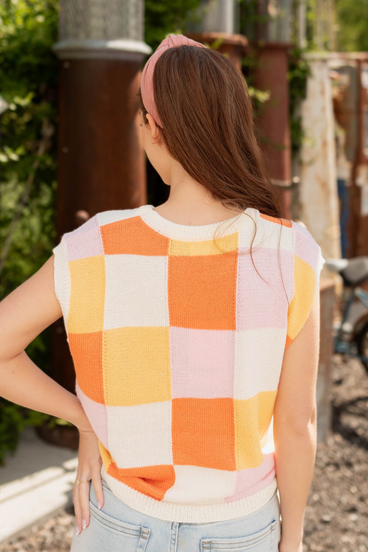 Back view of the orange checkered sweater vest