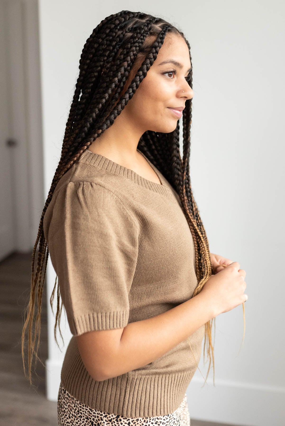 Side view of the the taupe short sleeve sweater