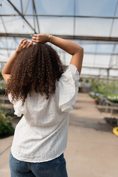 Back view of the white ruffle sleeve top