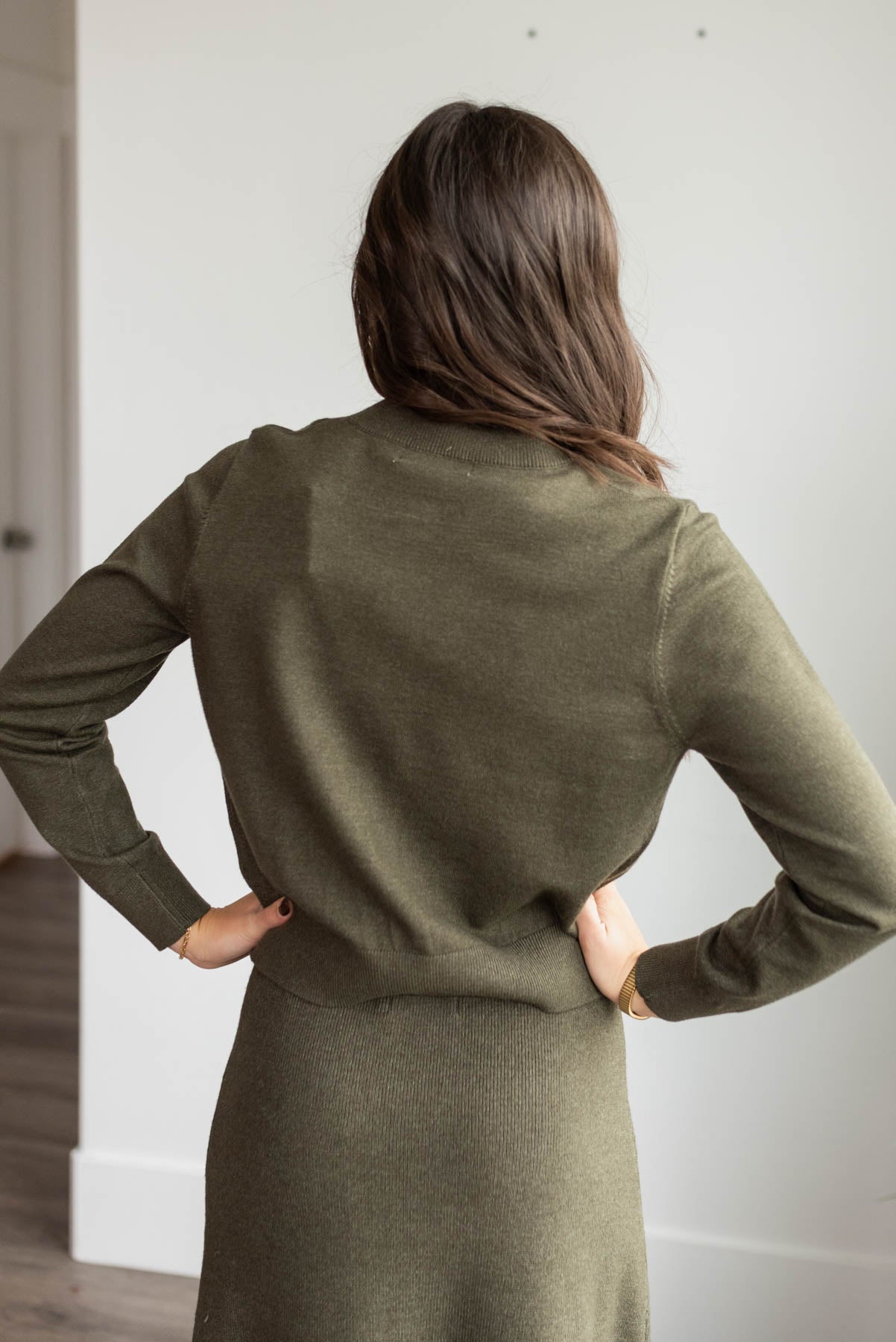 Back view of the dark olive knit sweater