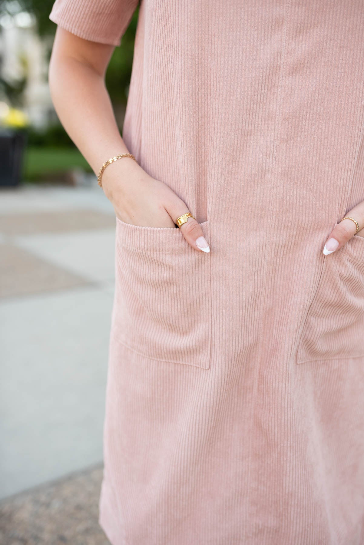 Close up of the fabric and pockets on the blush corduroy dress