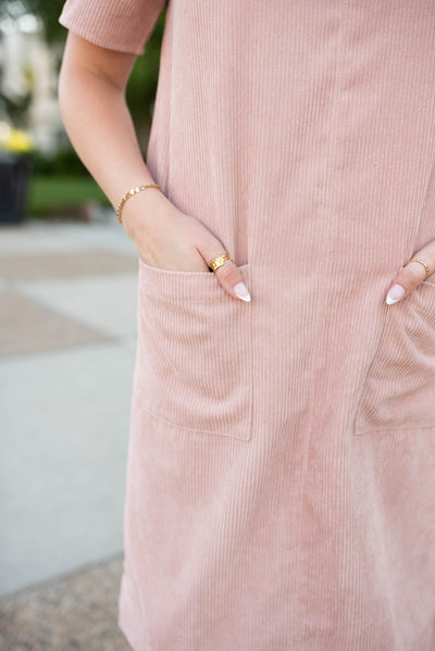 Close up of the fabric and pockets on the blush corduroy dress