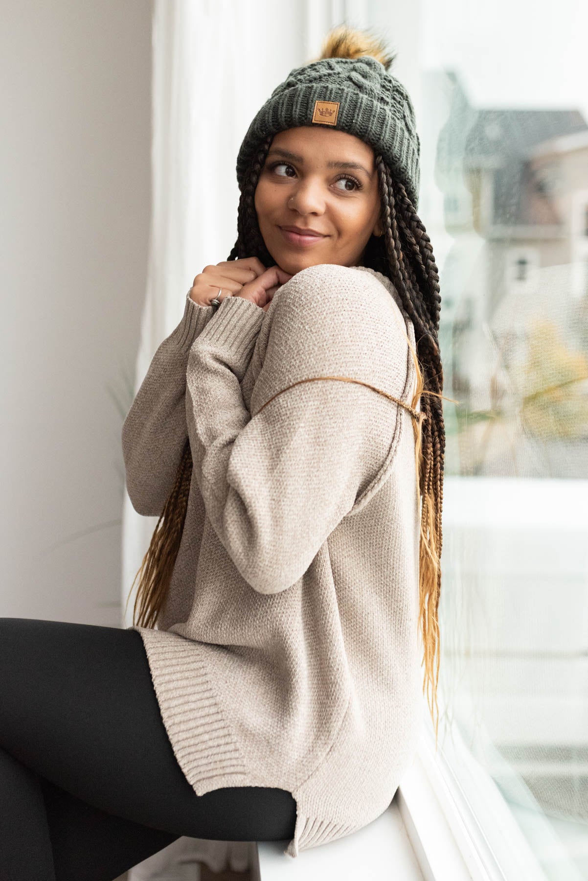 Side view of the taupe knited sweater