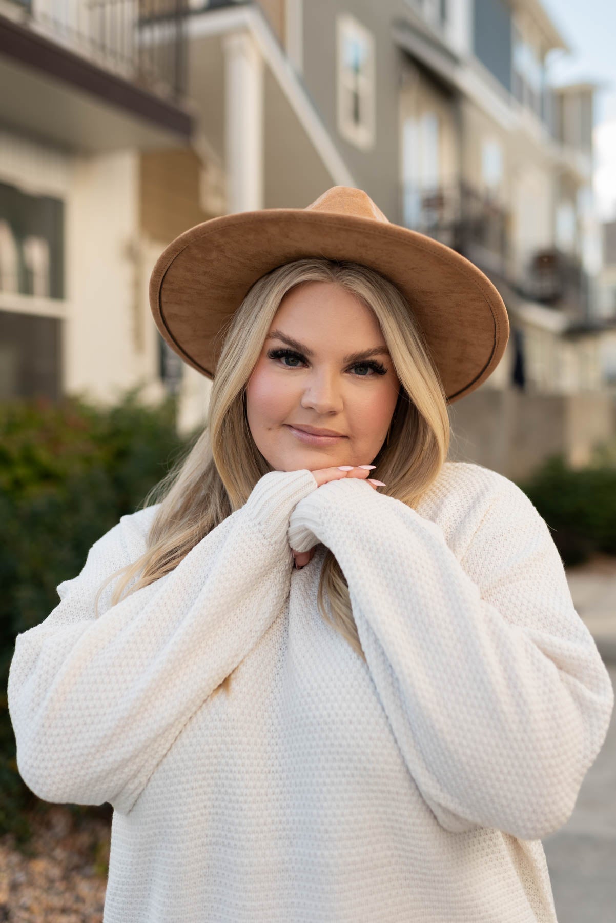 Front view of a plus size long sleeve bone sweater