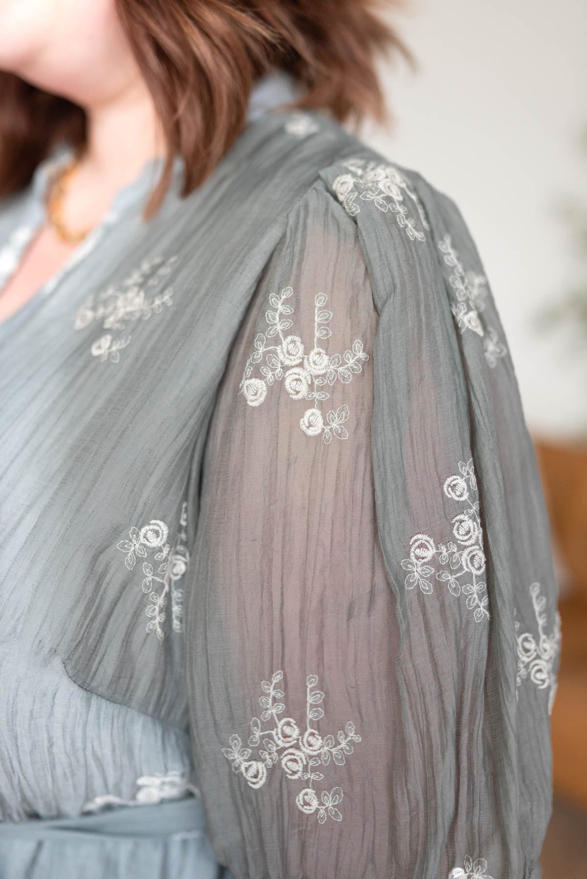 Close up of the fabric on the plus size dusty sage embroidered dress