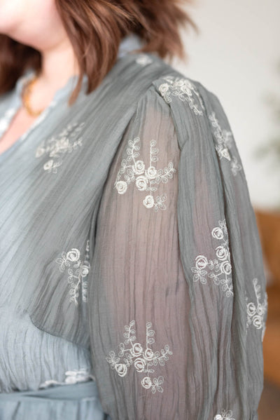 Close up of the fabric on the plus size dusty sage embroidered dress