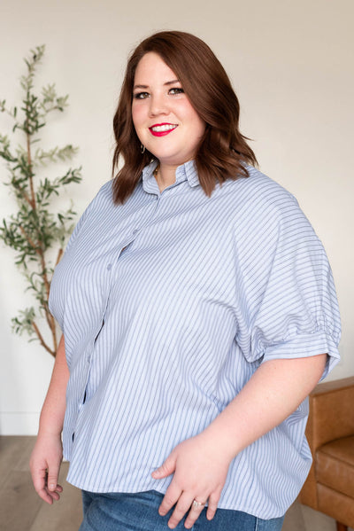 Side view of the plus size light blue stripe top