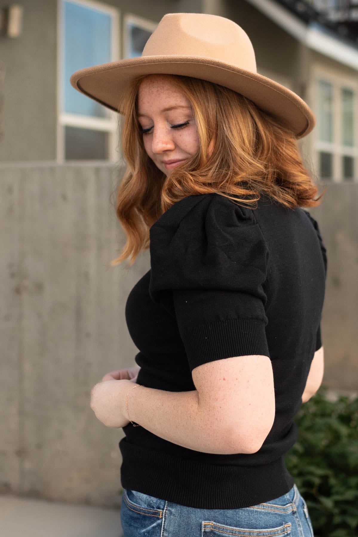 Side view of a medium short sleeve black top