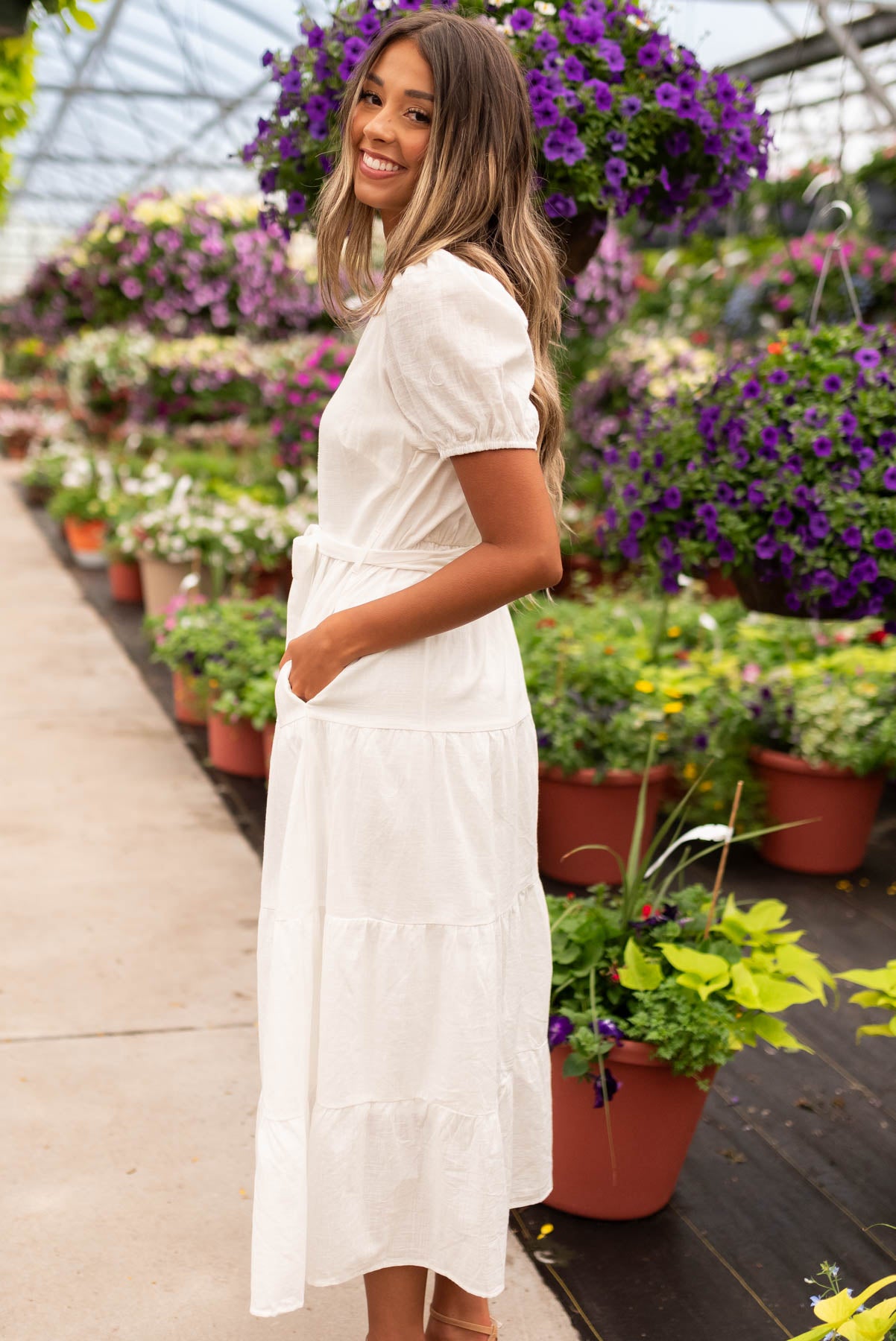 Side view of the off white button up dress