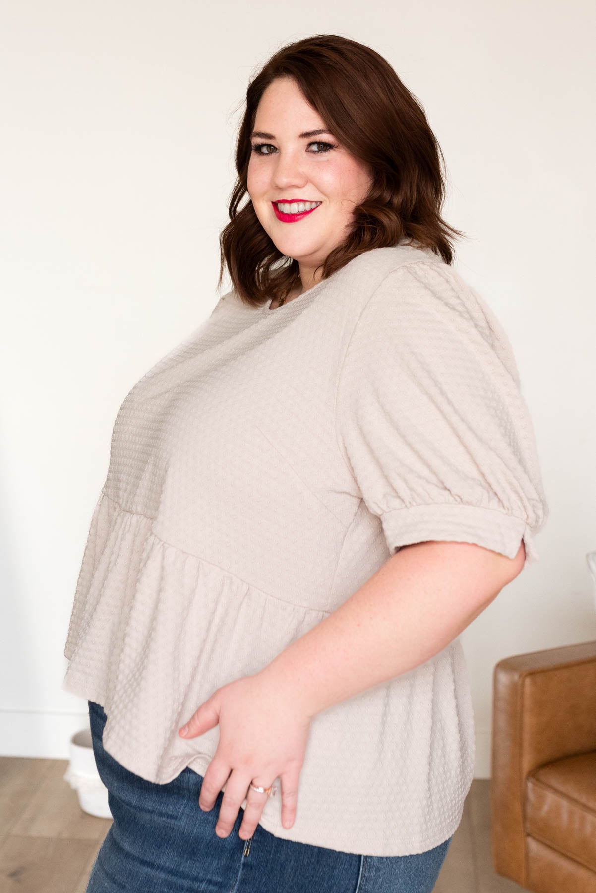 Side view of the plus size beige tiered top