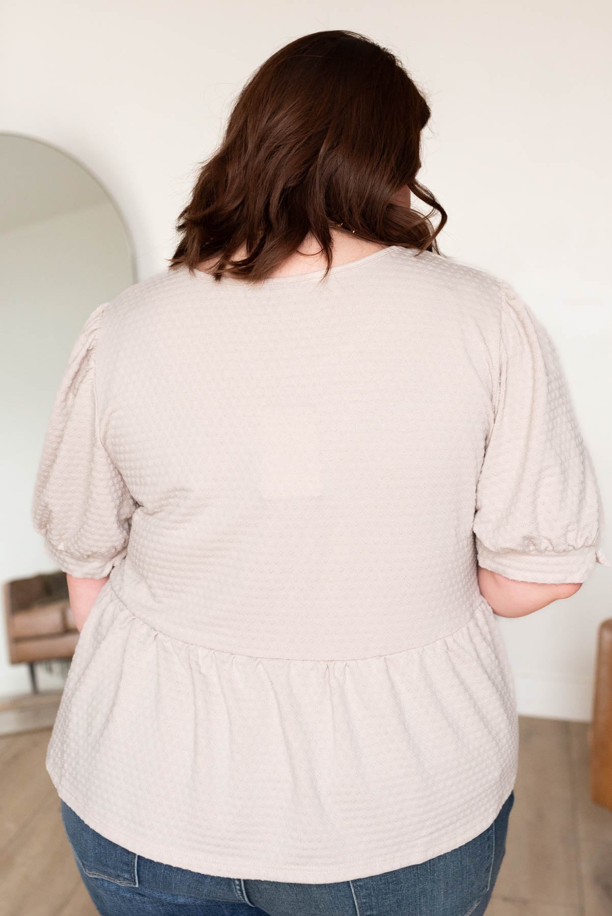 Back view of the plus size beige tiered top in plus size