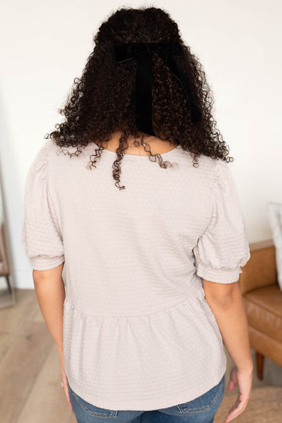 Back view of the beige tiered top