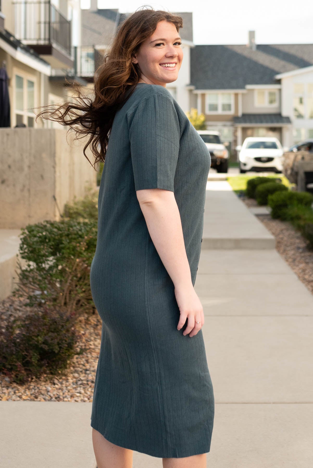 Side view of the dark green sweater dress