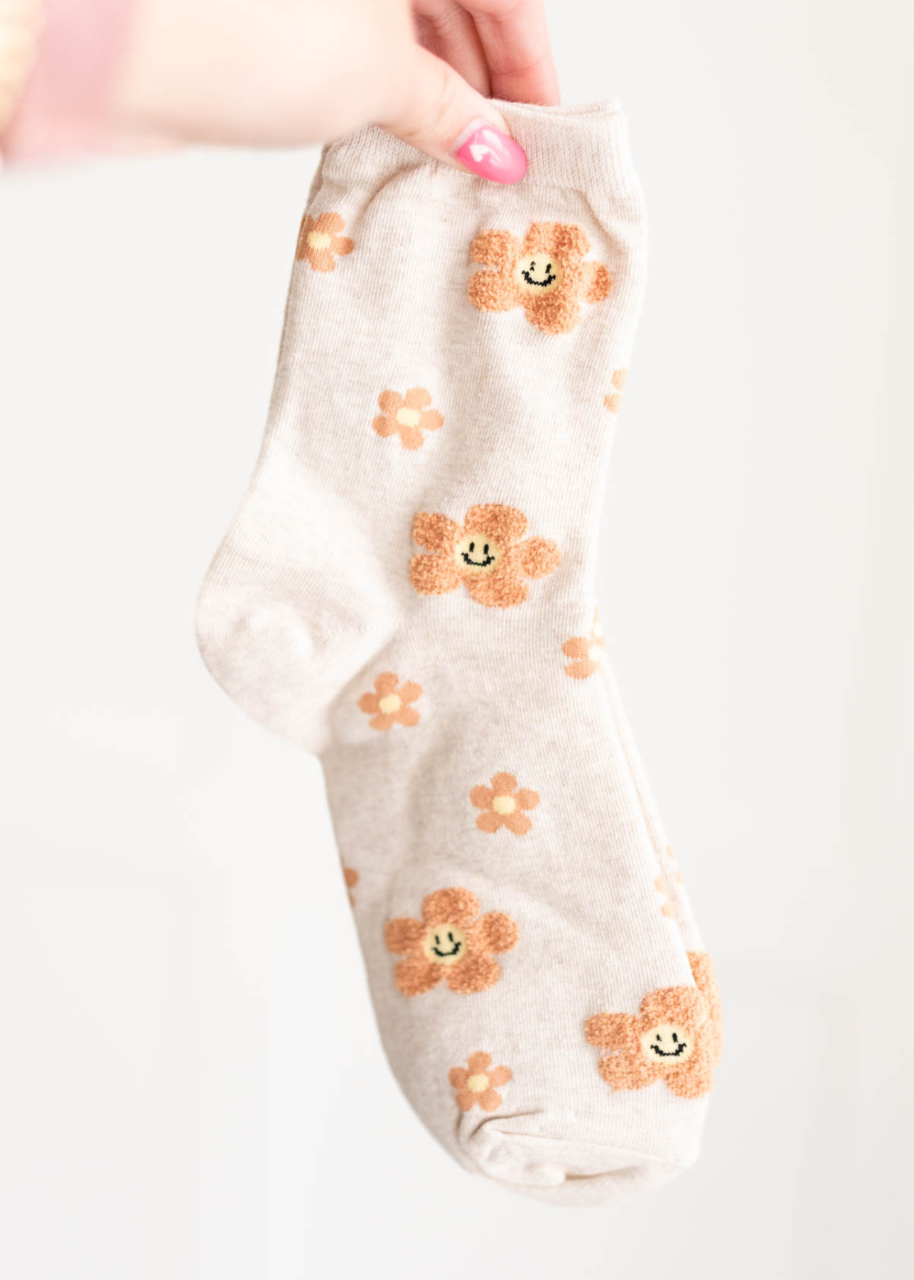 Taupe flower socks with smiley faces