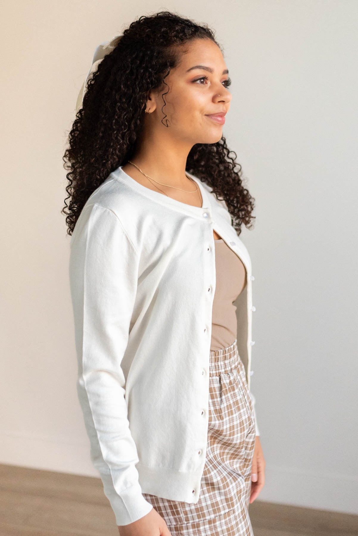 Side view of the ivory button down cardigan