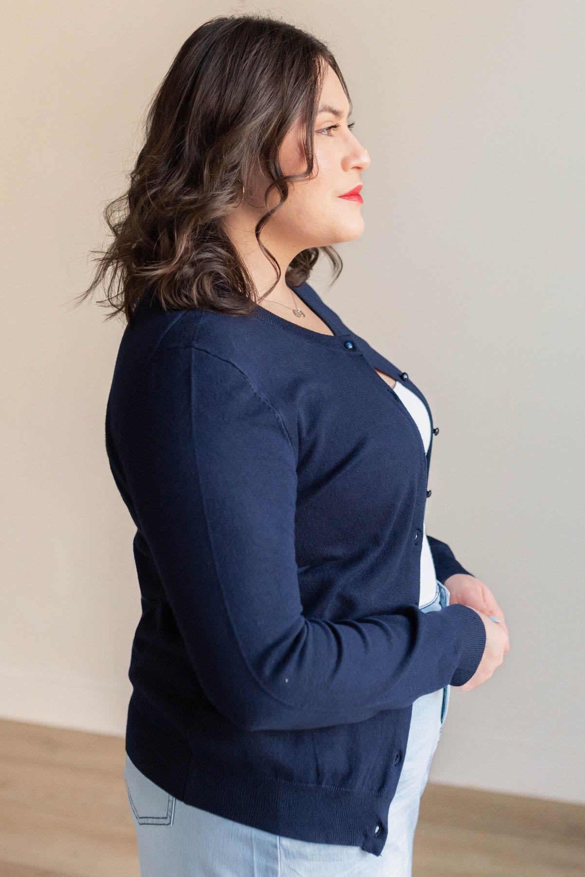 Side view of the plus size navy button down cardigan