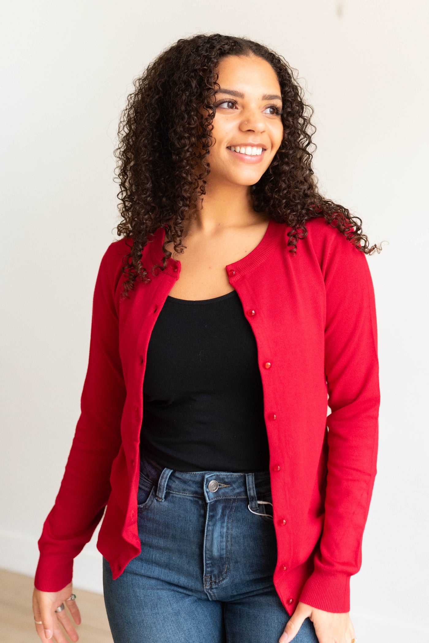 Small red button down cardigan with long sleeves and red button