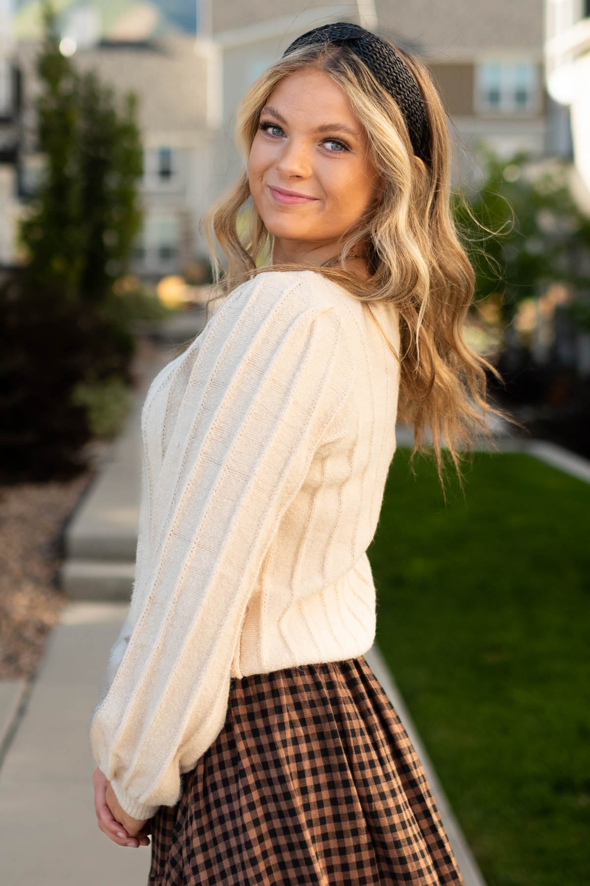 Side view of a taupe sweater