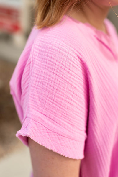 Sleeve of a mauve gauze top.